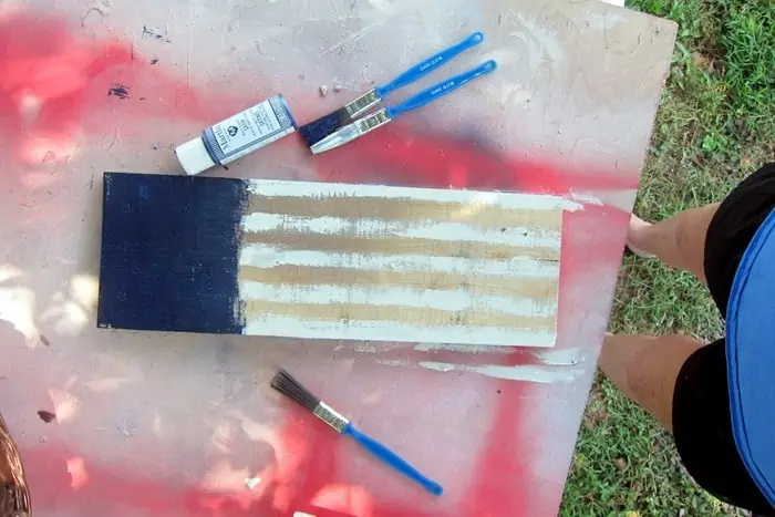 painting white stripes on a wood flag