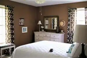 brown bedroom with hat wall decor