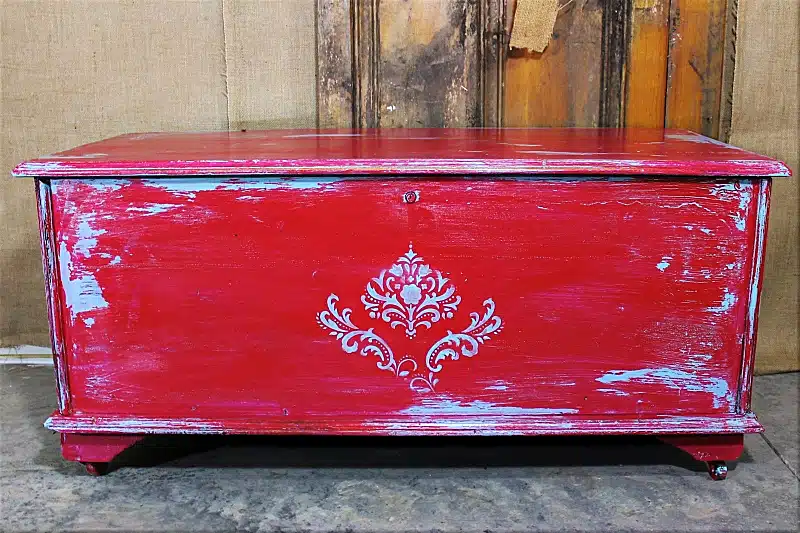 turquoise and red vaseline distressed cedar chest with a stenciled design