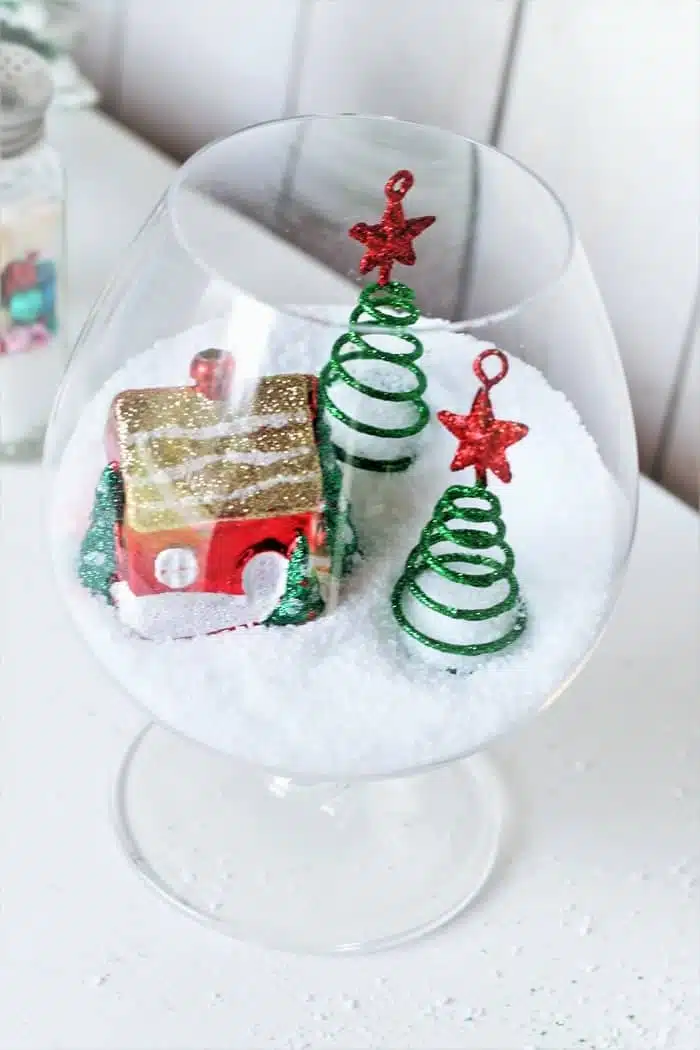 brandy glass with gingerbread house snow scene