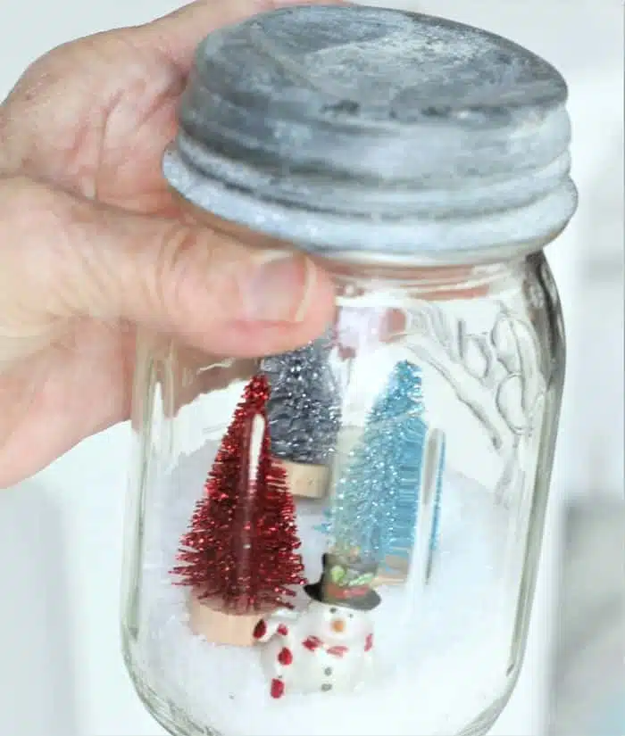 snowman snow scene in a vintage jar with zinc lid