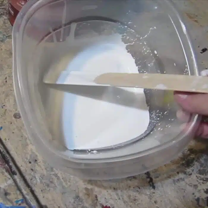 Thin white paint with water to make a whitewash for painted furniture