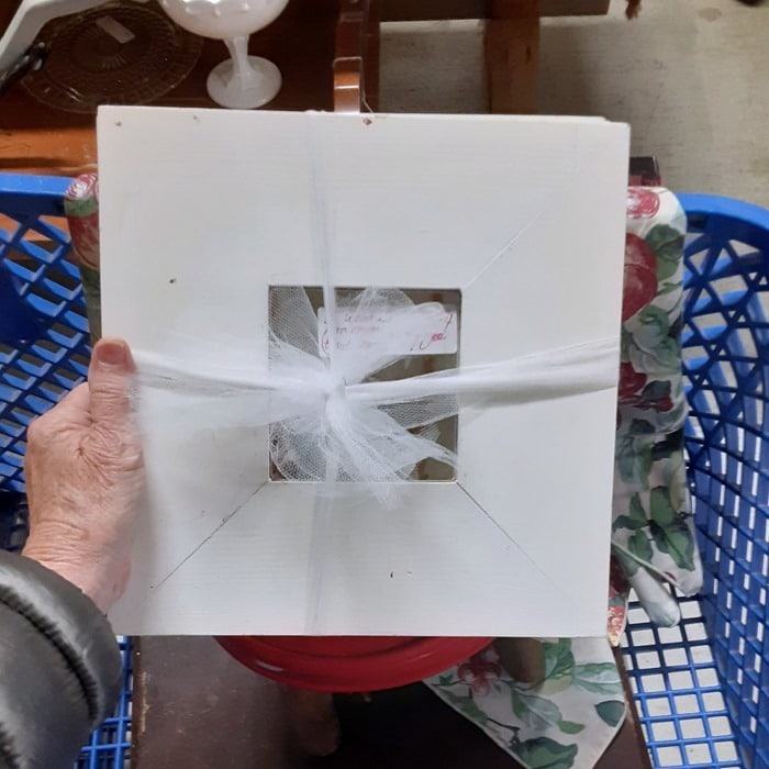 three small square mirrors with white frames