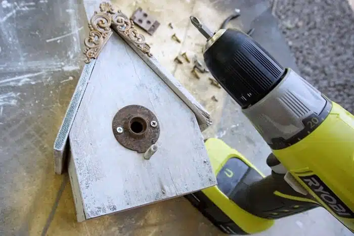 adding rusty details to a white birdhouse