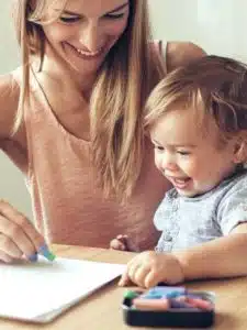 Mother playing with her 1,4 years old son, drawing together