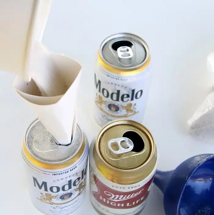 fill aluminum cans with sand to make vases