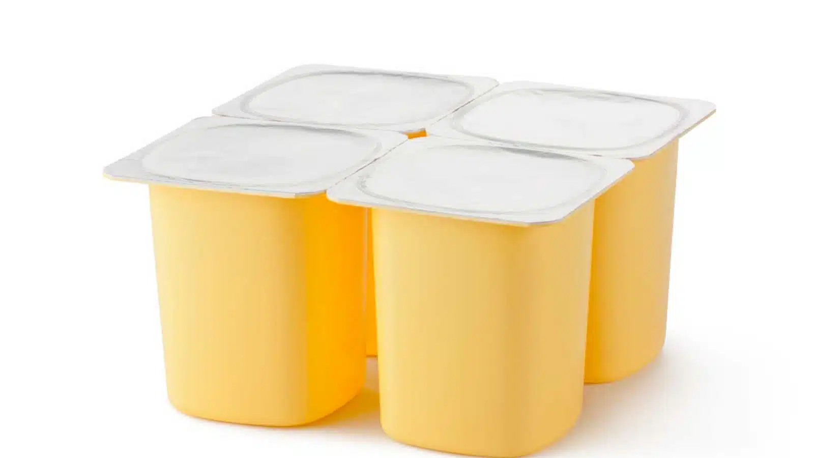 Four plastic containers for dairy products with foil lid. Isolated on a white.