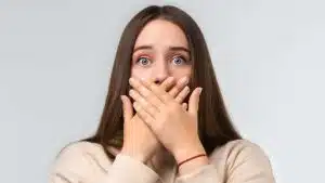 Shocked woman hand over mouth