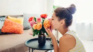Woman having flower vase.