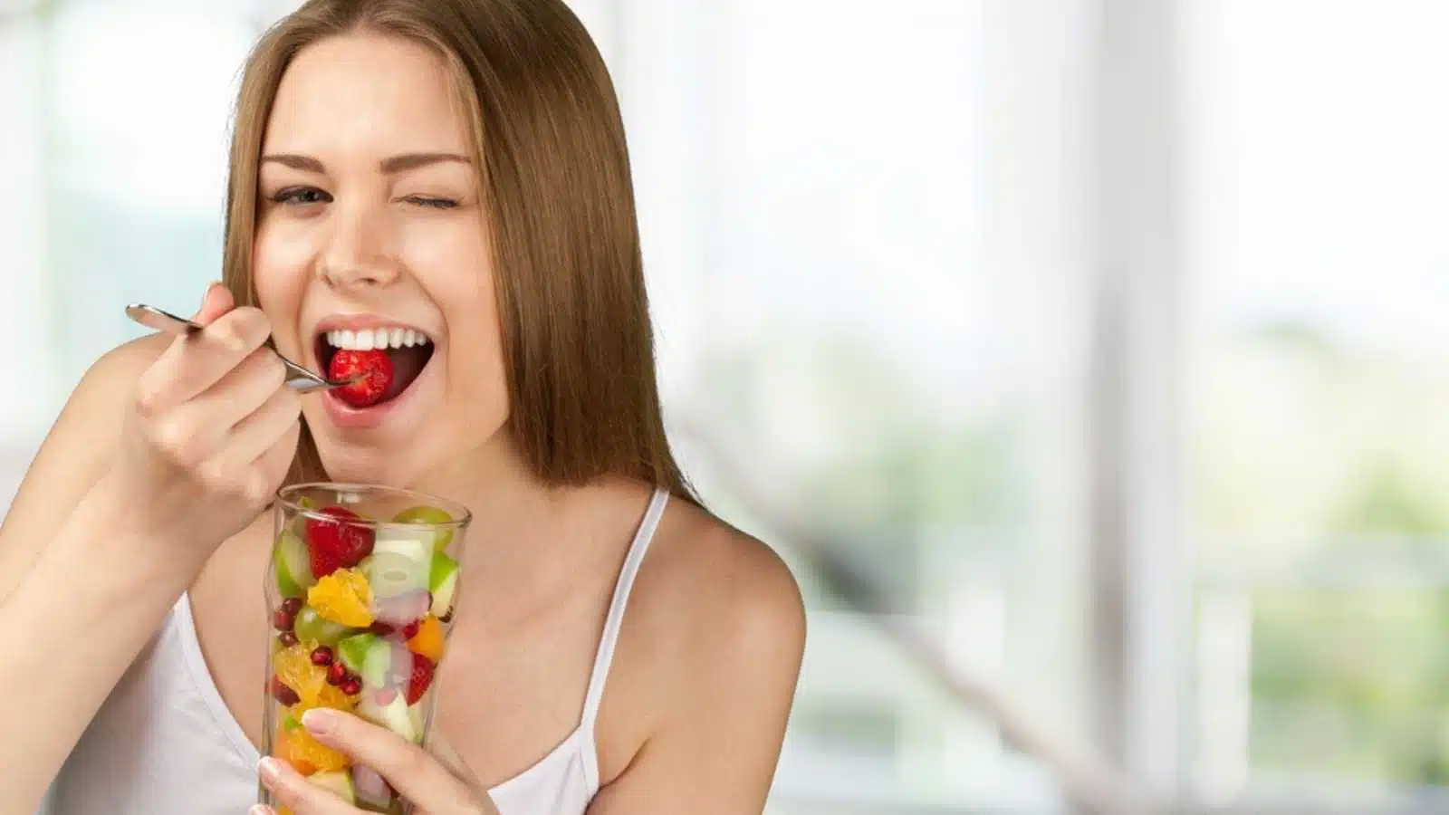 Woman eating different fruits