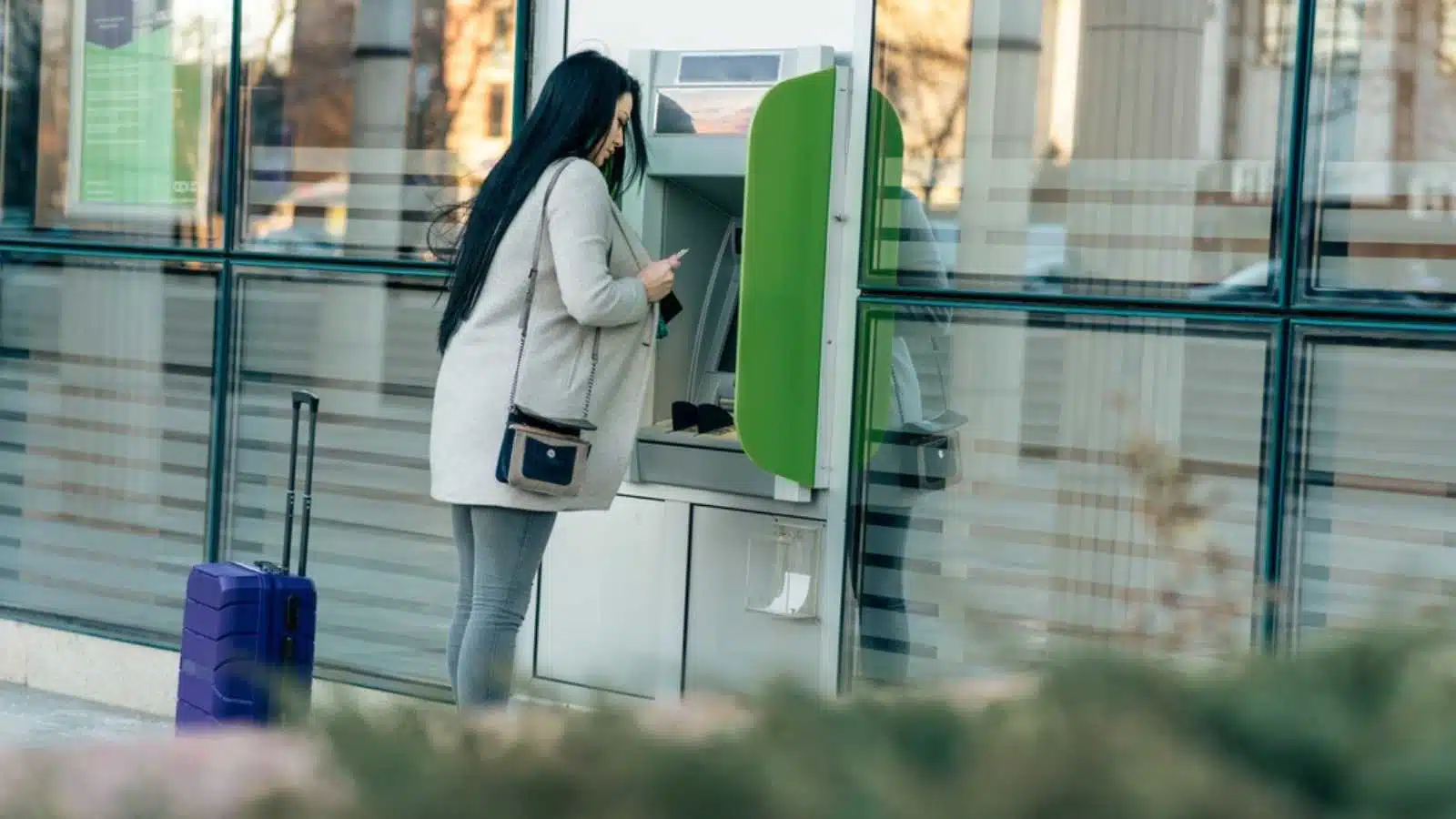 Woman using ATM