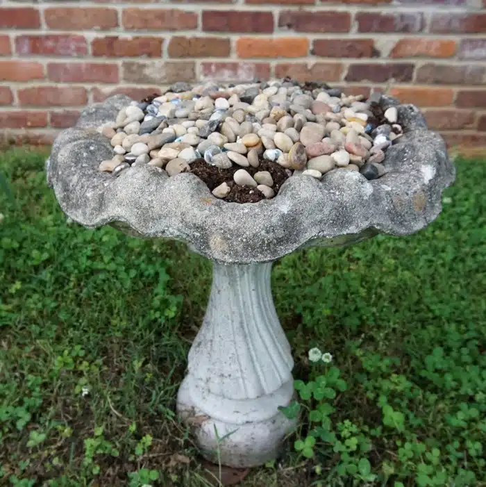 layer rocks on bird bath