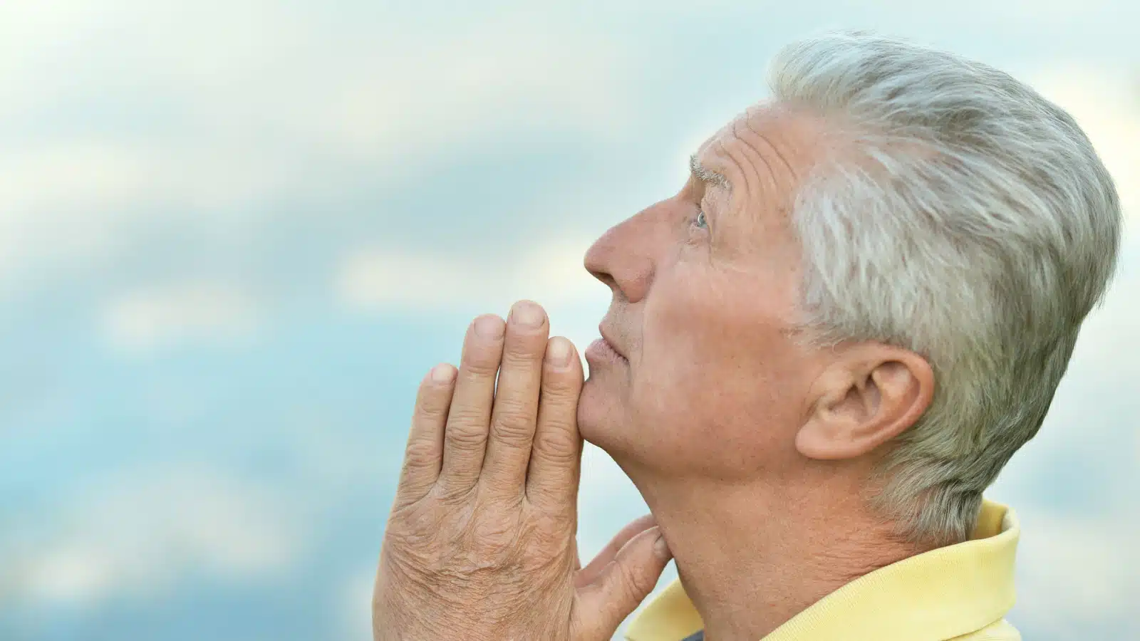 older man praying peace
