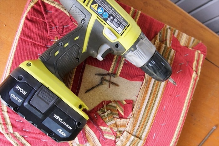remove a padded fabric chair seat using a drill to remove the screws