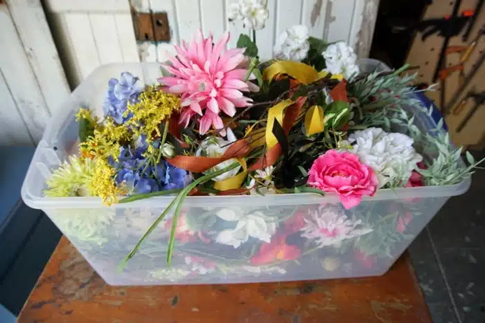 tote full of artificial flowers for a wreath project