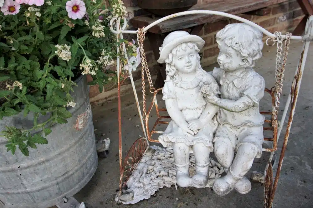 Boy and Girl in swing concrete statue