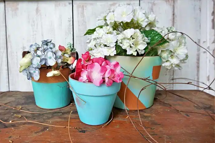 small and large terracotta flower pots spray painted