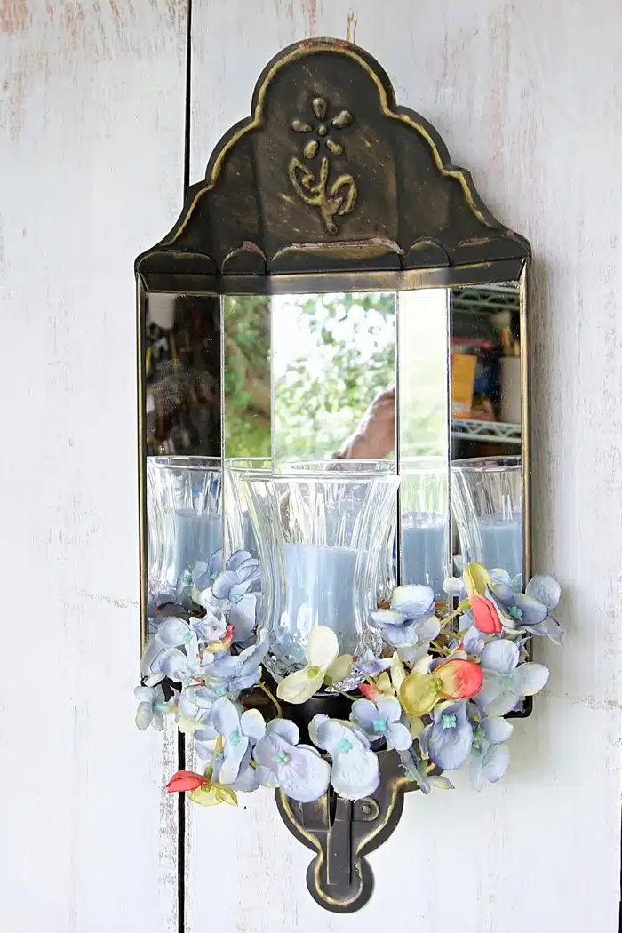 vintage Home Interior mirrored sconce with candle and flowers