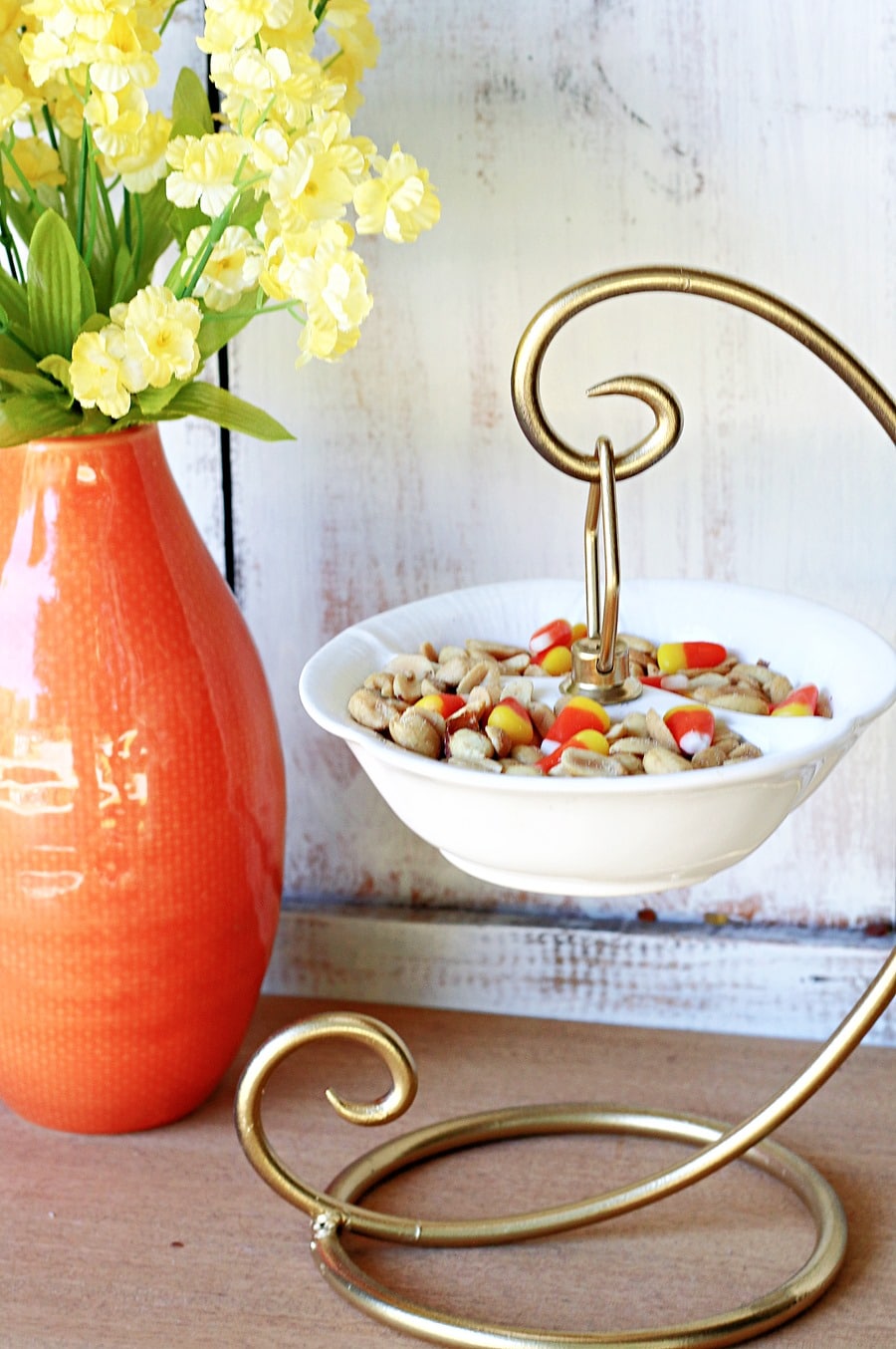 upcycled candy dish from the thrift store holds candy corn and peanuts