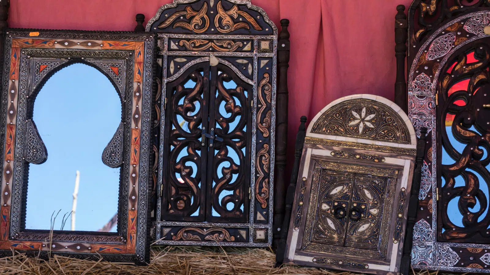 Four vintage mirrors against a wall.