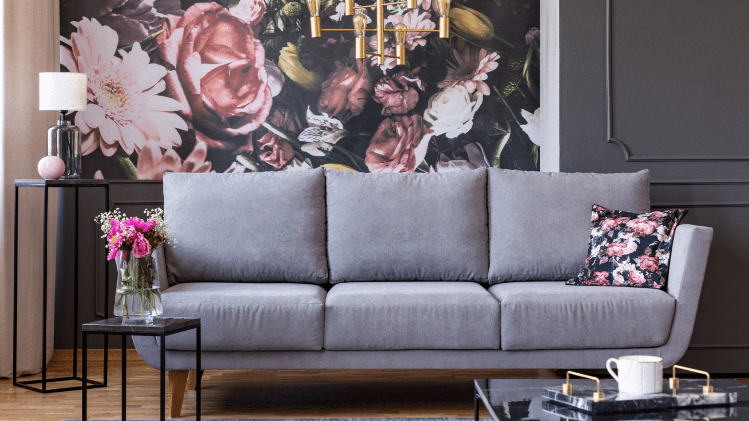 Wall art on a wall behind a gray couch.