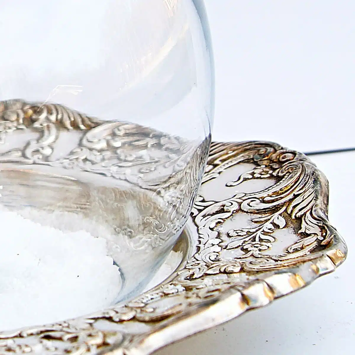 snow scene created with a silver plate dish and clear bowl globe 4