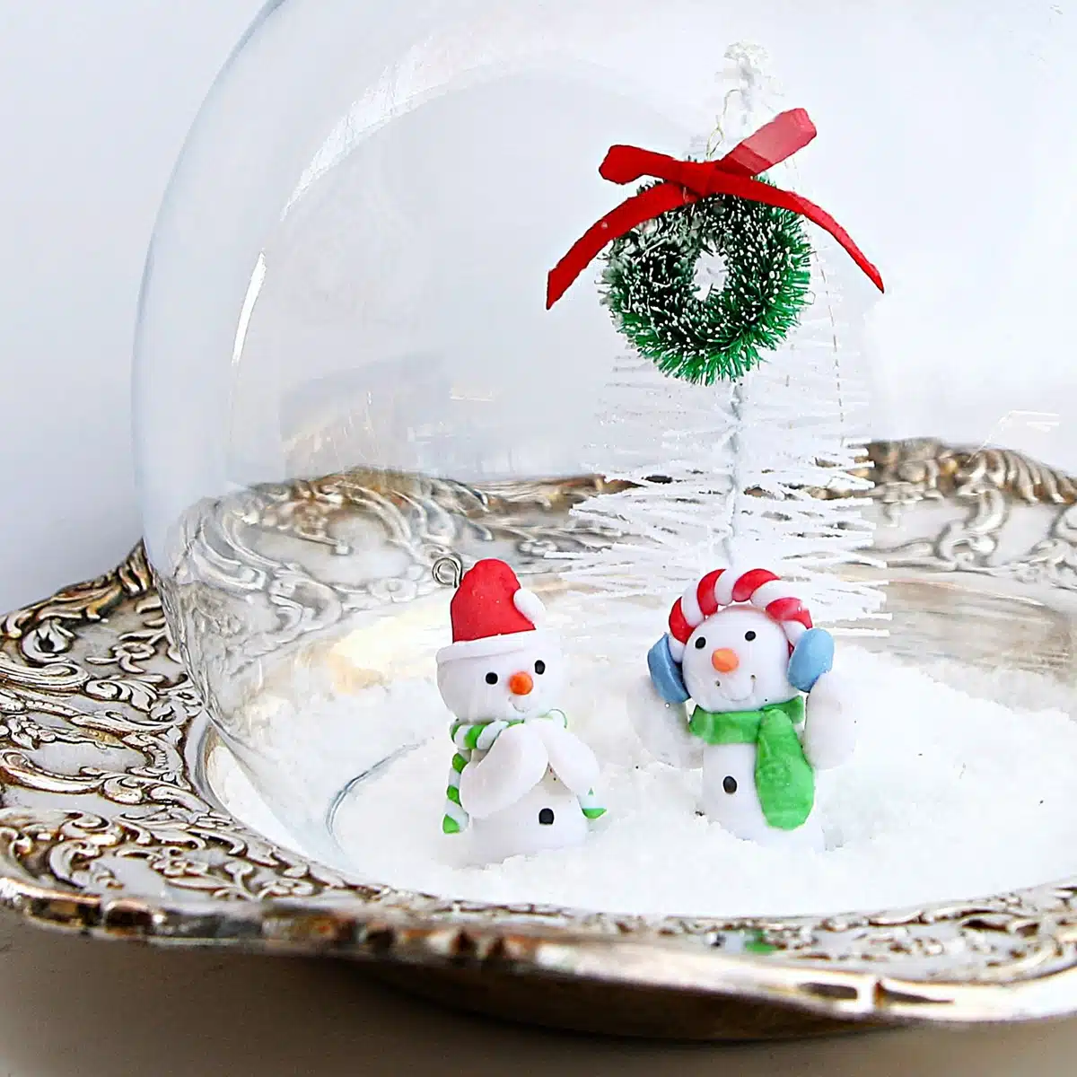 snow scene created with a silver plate dish and clear bowl globe 5
