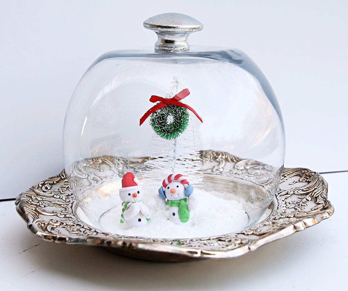 snow scene under glass on a silver plate tray