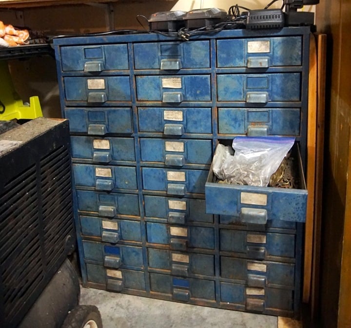 metal cabinet in the workshop with hardware and drawer pulls