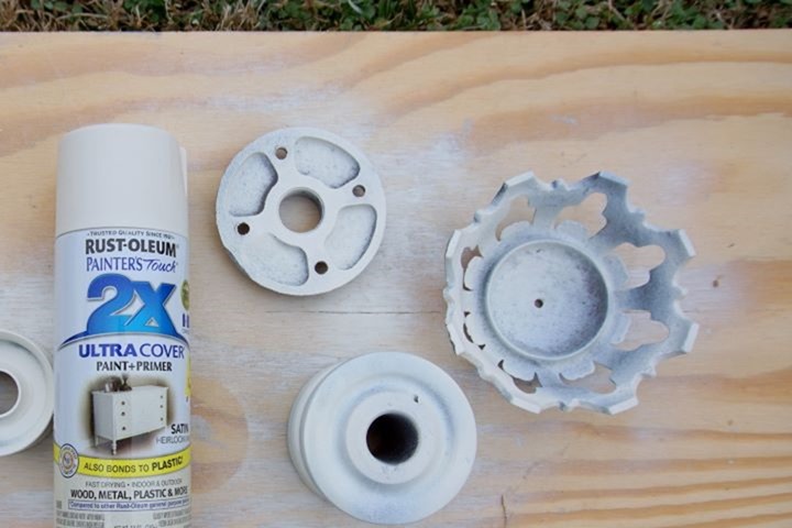 spray paint salvaged iron pieces white to make an upcycled candleholder