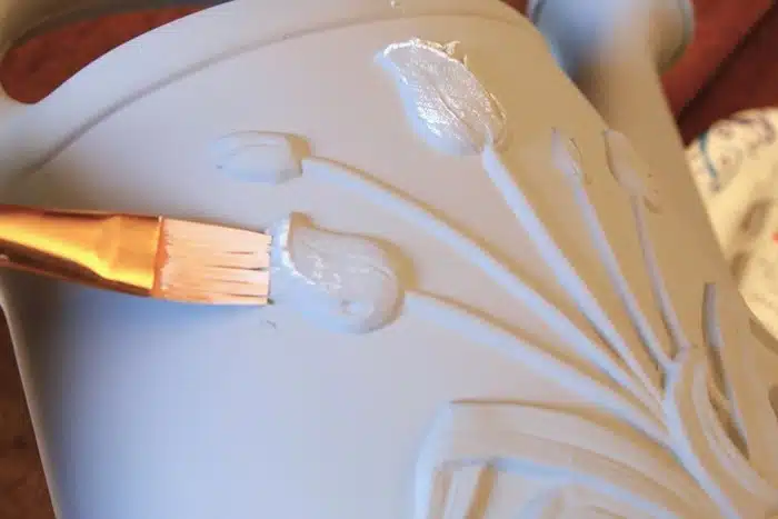 dry brush painting a plastic watering can