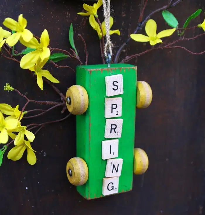 Spring craft created with Scrabble tiles and toy parts and pieces