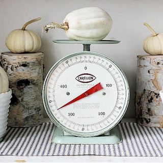 white pumpkins on antique scale