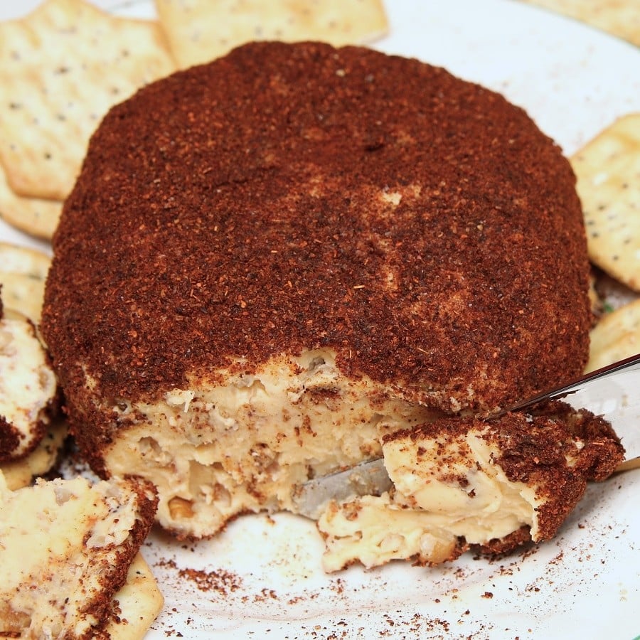 cheese ball made with cream cheese and Velveeta cheese rolled in chili powder