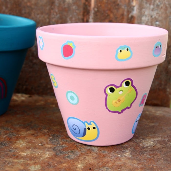 terra cotta pot painted pink with Dollar Tree stickers