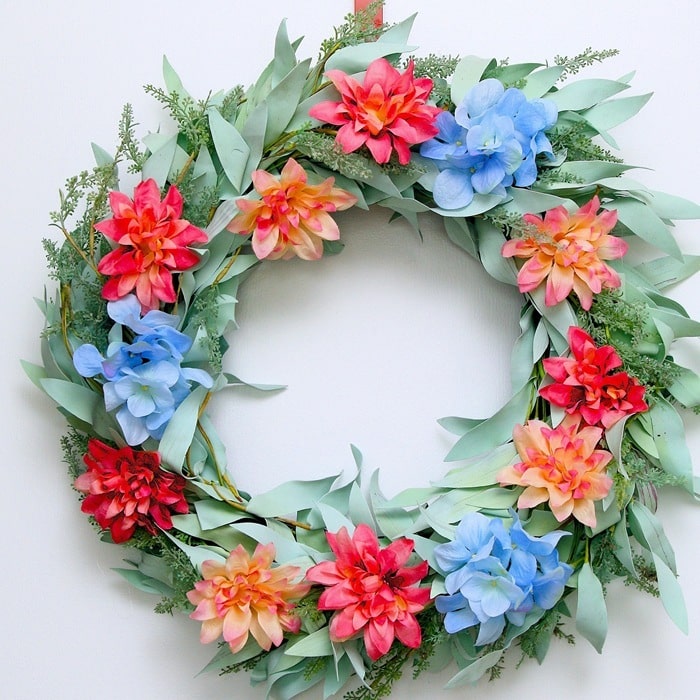 thrift store wreath refreshed with flowers