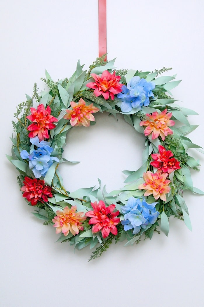 how to refresh a thrift store wreath by adding new flowers using a glue gun