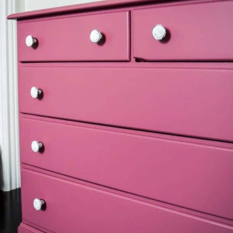 bright pink painted nursery dresser