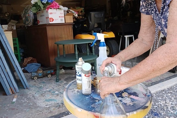 spray metallic spray paint inside a bottle, jar, or vase to make faux mercury glass