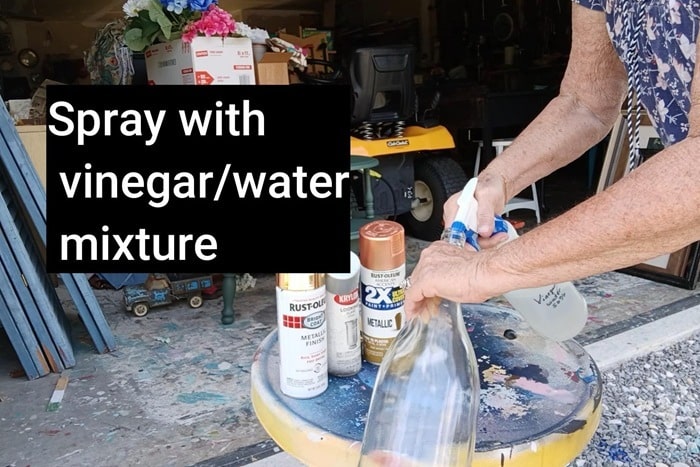 to make a faux mercury glass bottle first spray it inside with a vinegar water mixture