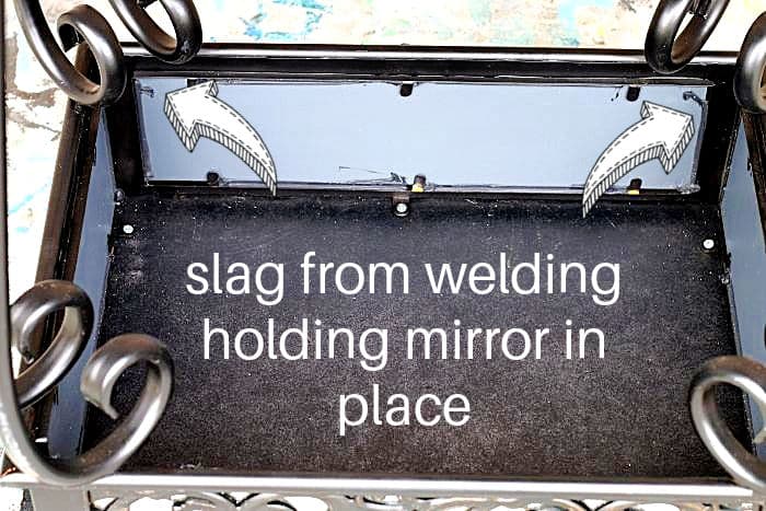 slag from welding holding mirror in place