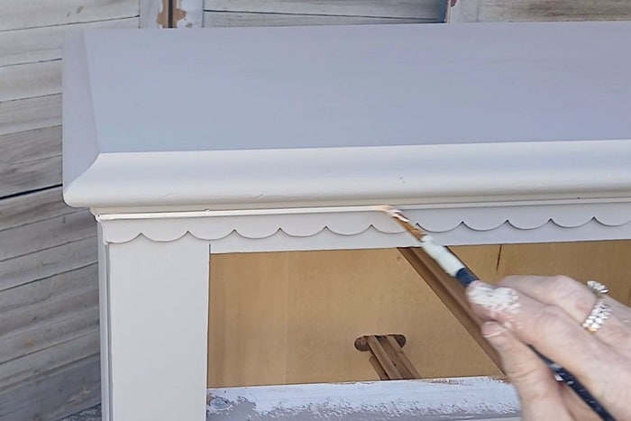 use a small artist brush to whitewash and paint small details on furniture