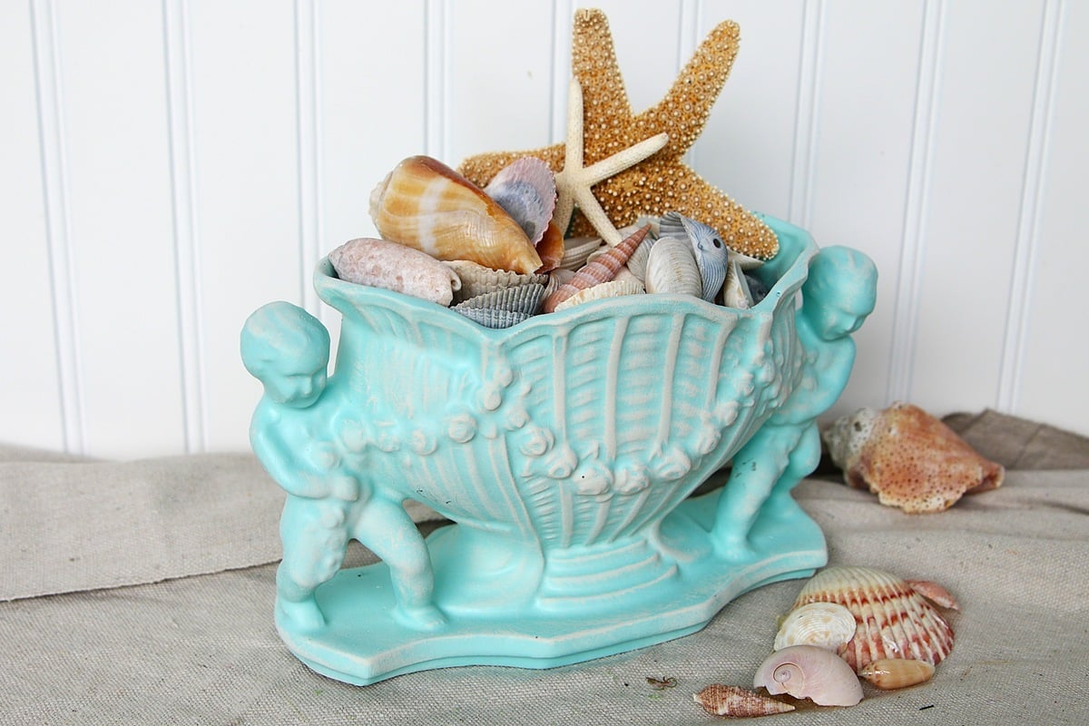 vintage planter painted with aqua spray paint and dry brushed white