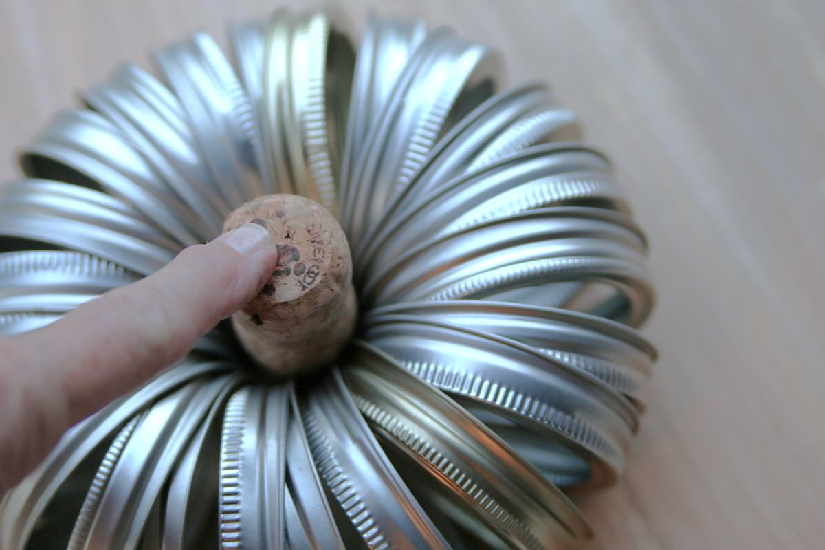 diy pumpkin made from canning jar lids with a cork stem